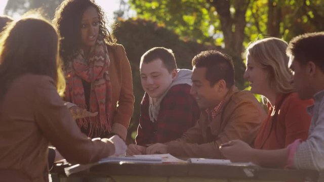 Group of college students on campus meeting outdoors