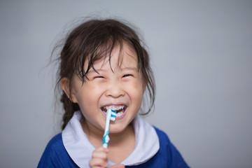 asian little girl brush teeth