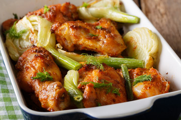 Delicious chicken baked with fresh fennel in a baking dish close-up. horizontal