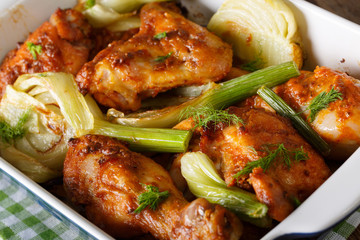 Moroccan delicious chicken baked with fennel in a baking dish macro. horizontal