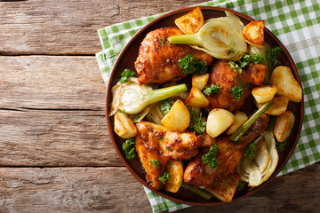 Moroccan food: pieces of chicken baked with fennel and potatoes close-up. horizontal top view