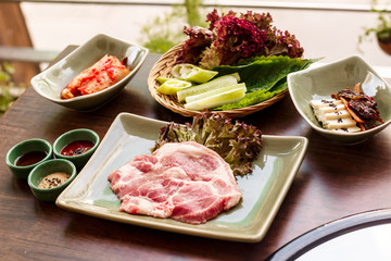 pork stake, pieces of crude meat prepared for preparation with greens