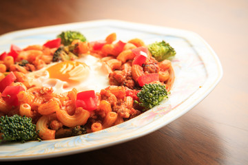 Stir-fried macaroni and pork on wooden background