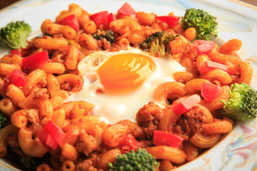 Stir-fried macaroni and pork on wooden background