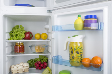 Open fridge full of fresh fruits and vegetables