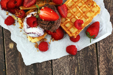 belgian waffles with ice cream, caramel sauce and fresh berries