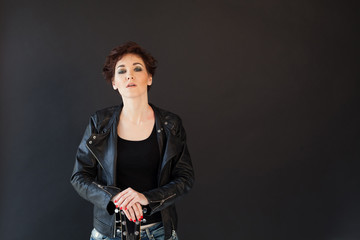 short hair girl in glasses and fancy leather jacket