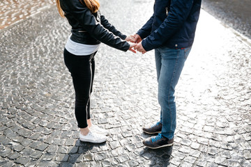 Cropped image of a couple holding hands and facing each other