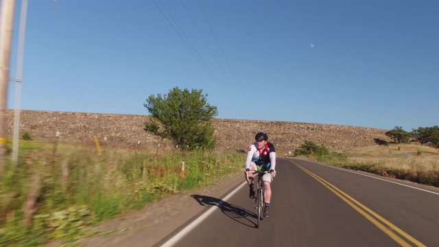 Man riding bicycle on country road