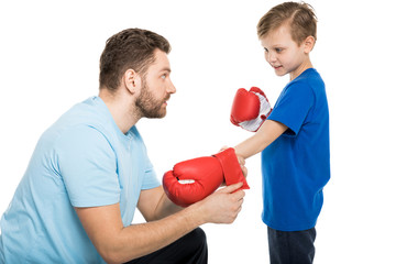 Side view of father and son with boxer gloves isolated on white