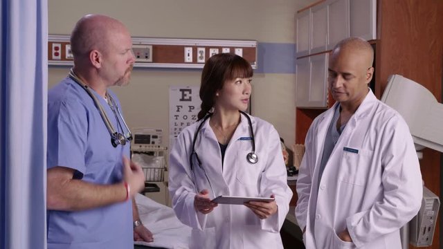 Medical personnel with digital tablet have discussion