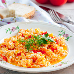 Homemade scrambled eggs with tomatoes, square