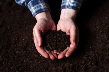 Female farmer handful of soil