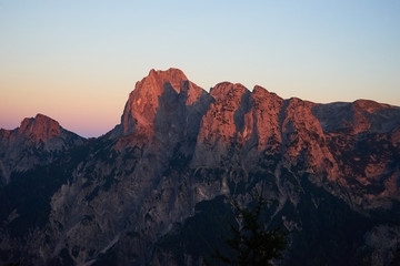 Glowing red mountains in the Alps at dawn