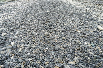 light black round stone and pebble way with selective focus