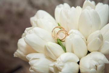 Fototapeta na wymiar Wedding rings on bride's bouquet