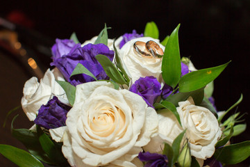 Wedding rings on bride's bouquet