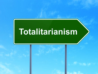 Politics concept: Totalitarianism on road sign background