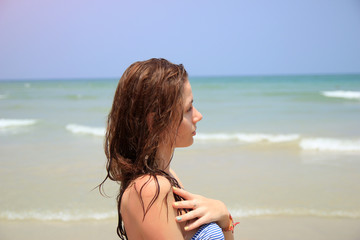Beautiful woman on the beach. Sea background. Close up