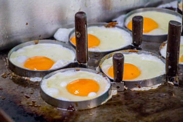 eggs flying in circle mold on pan