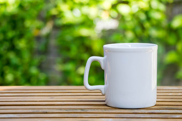 white coffee mug on wood table
