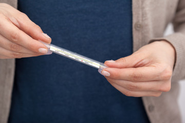 Sick women with a thermometer