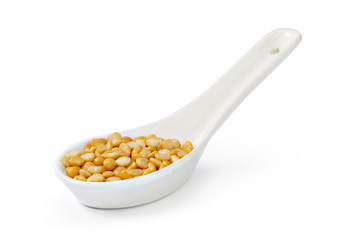 Dry yellow split peas isolated on white.