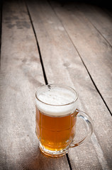 glass beer on wood background