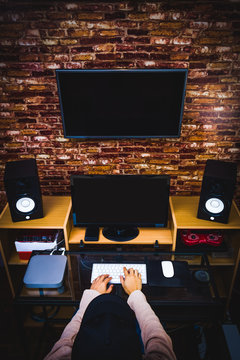man working on computer in modern loft office, digital editing studio