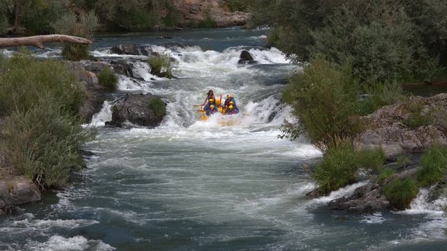 Super slow motion shot of group of people white water rafting