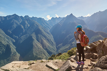 Woman with backpack on mountain background