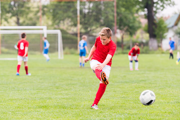 Kids soccer football - children players match on soccer field