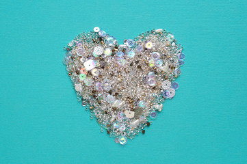  Blue background with heart of sequins and beads 