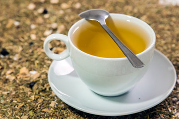 Cup of Tea. A hot white cup of tea on a saucer with a teaspoon.. A cup of tea on the table