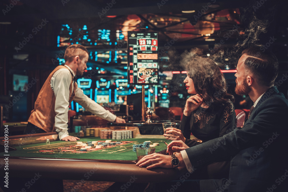 Wall mural upper class couple gambling in a casino