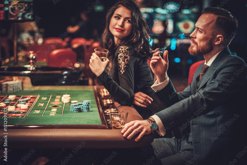 Wall mural upper class couple gambling in a casino