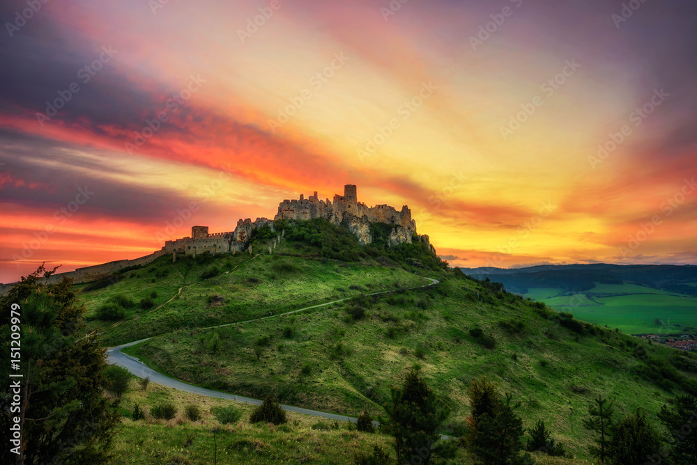 Wall mural dramatic sunset over the ruins of spis castle in slovakia