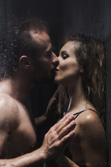 Woman kissed by a man during romantic shower
