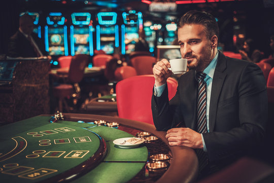 Upper Class Man Behind Gambling Table In A Casino