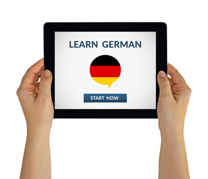 Hands holding digital tablet computer with learn german concept on screen. Isolated on white. All screen content is designed by me