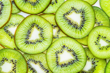 Kiwi fruits slices green background.