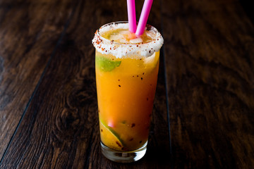 Mexican Michelada Cocktail with beer, lime, ice and spices..