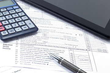 In the office on the table, a report, coffee, a tablet with a pen