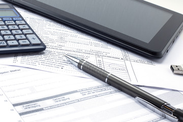 In the office on the table, a report, coffee, a tablet with a pen