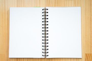 Vintage book, open, on wooden table.