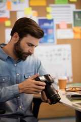 Photographer using camera in creative office