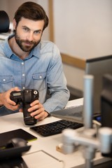 Professional photographer sitting in creative office
