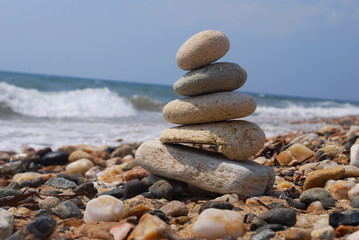 Stack of stones on the rocky beach. Concept of balance and harmony at the sea