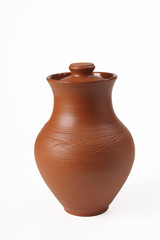 Fototapeta na wymiar Ceramic (from red clay) jug with a lid on a white background. Isolated. Close-up