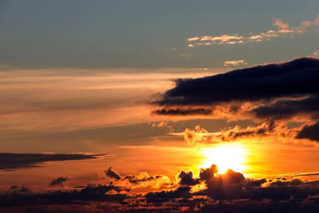 Bright sunset in the night cloudy sky